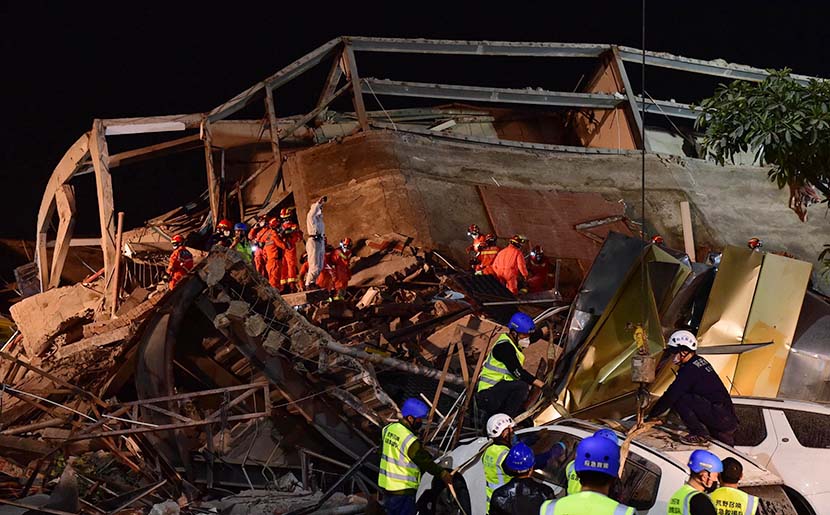 A search and rescue team combs through rubble looking for survivors after a hotel collapsed in Quanzhou, Fujian province, March 8, 2020. Dozens of close contacts of COVID-19 patients had been under quarantine in the hotel. Lin Shanchuan/Xinhua