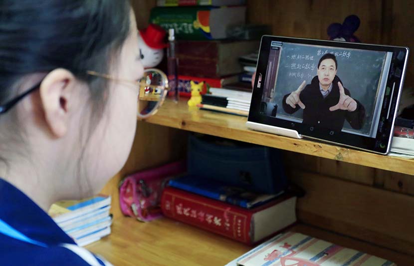 A girl watches an online lecture at her home in Yuncheng, Shanxi province, Feb. 9, 2020. IC