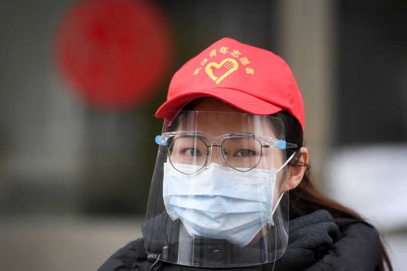 A young volunteer working at a residential community in Wuhan, Hubei province, March 7, 2020. Chen Yehua/Xinhua