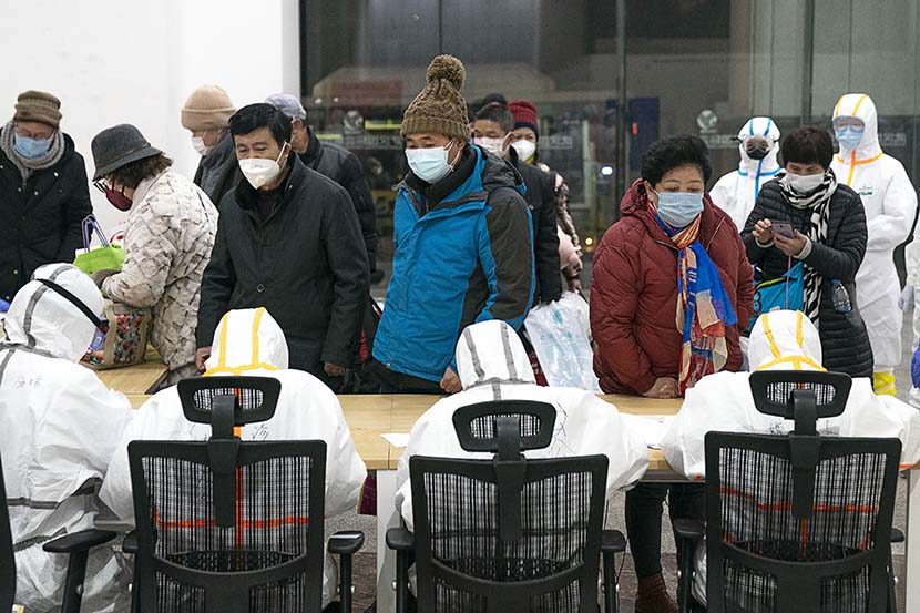 Medical workers register incoming patients at a temporary hospital in Wuhan, Hubei province, Feb. 5, 2020. Xinhua