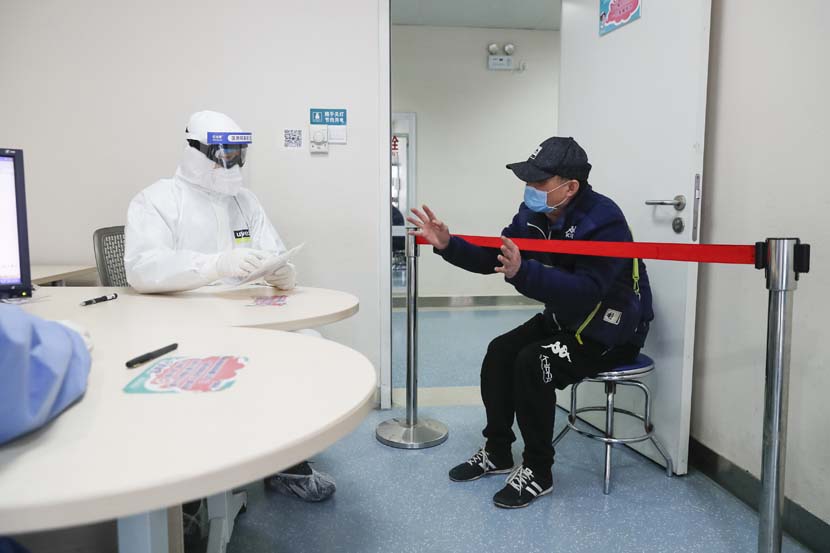 A patient talks to a urologist at Wuhan Union Hospital, as more medical facilities in the city return to treating patients with conditions other than COVID-19, Hubei province, March 16, 2020. Xinhua