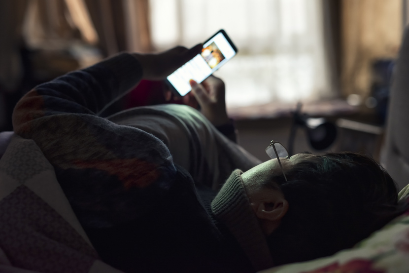 Zhang’s mother looks at her phone at home in Wuhan, Hubei province, January 2020. Zhang Xizhi for Sixth Tone