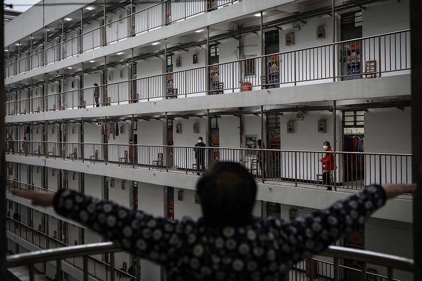 A person under observation exercises at the quarantine center set up in the dormitories of Wuhan Vocational College of Software and Engineering in Wuhan, Hubei province, Feb. 27, 2020.  Zhao Di/China Youth Daily
