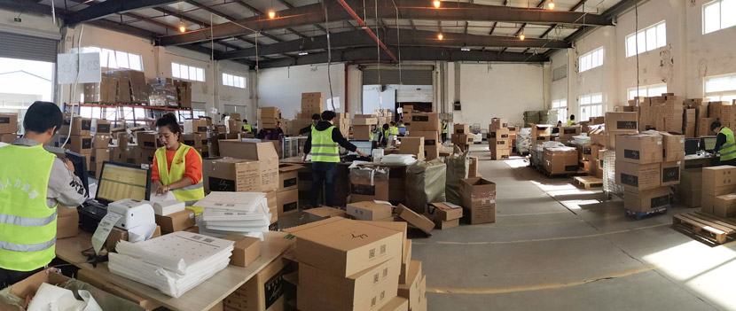 Workers package clothes for Singles’ Day — China’s annual online shopping bonanza — at a warehouse in Shanghai, November 2019. Courtesy of Lu Jianxin