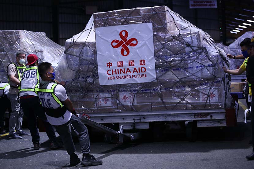 Workers transport medical supplies donated from China at an airport in Manila, Philippines, March 21, 2020. Yang Ke/Xinhua