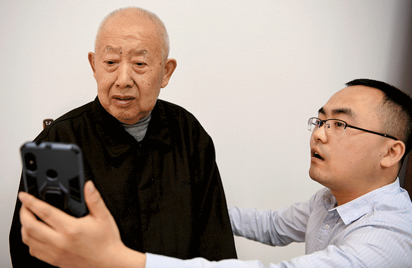 A GIF shows a volunteer helping elderly citizens register on a facial recognition-enabled pensions platform in Hebei, Anhui province, May 10, 2019. Liu Junxi/Xinhua