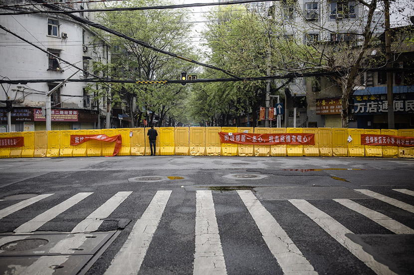 A man looks over a barrier in Wuhan, Hubei province, March 22, 2020. Gerry Yin/Wild Photos