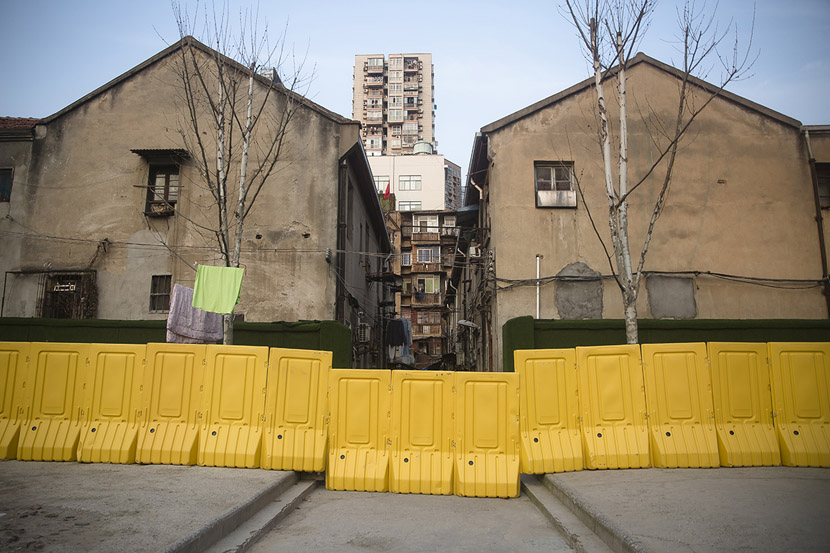 Barriers close off a residential community in Wuhan, Hubei province, Feb. 23, 2020. After the yellow walls were erected in mid-February, residents, still preoccupied with the outbreak, largely left them alone. Gerry Yin/Wild Photos