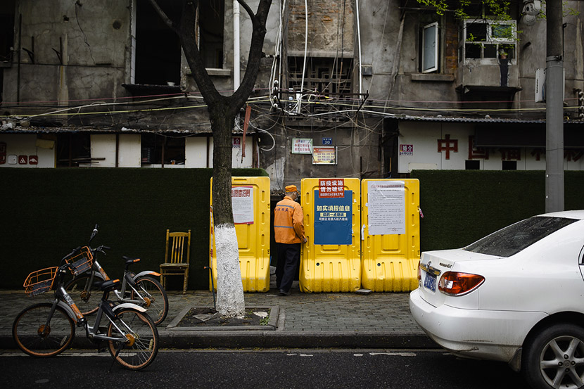 A sanitation worker enters a residential community in Wuhan, Hubei province, March 22, 2020. Gerry Yin/Wild Photos