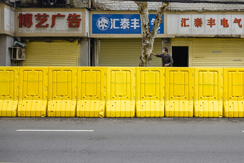 A man stands on a platform while waiting for a delivery in Wuhan, Hubei province, March 22, 2020. Gerry Yin/Wild Photos