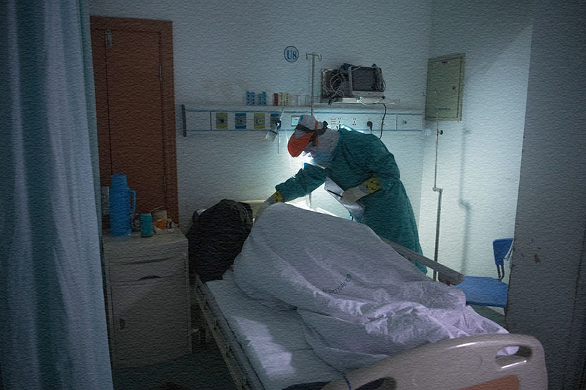 A nurse from the Guangdong medical support team adjusts the blankets of a patient in Hankou Hospital in Wuhan, Hubei province, March 1, 2020. Southern Visual/People Visual
