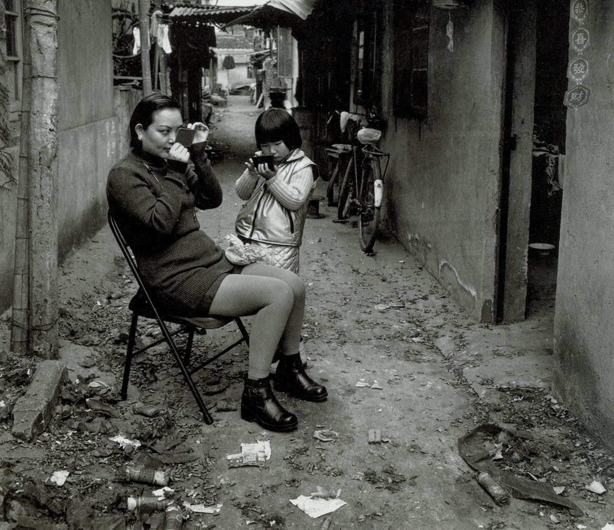 Residents apply makeup before visiting their relatives on the first morning of the Lunar New Year, Dongchang Road, Shanghai, 1999. Courtesy of Wu Jianping