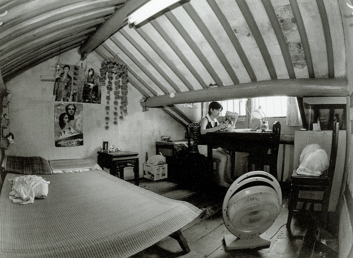 A nursing student studies in her loft at home on Dongchang Road, Shanghai, 1998. Courtesy of Wu Jianping