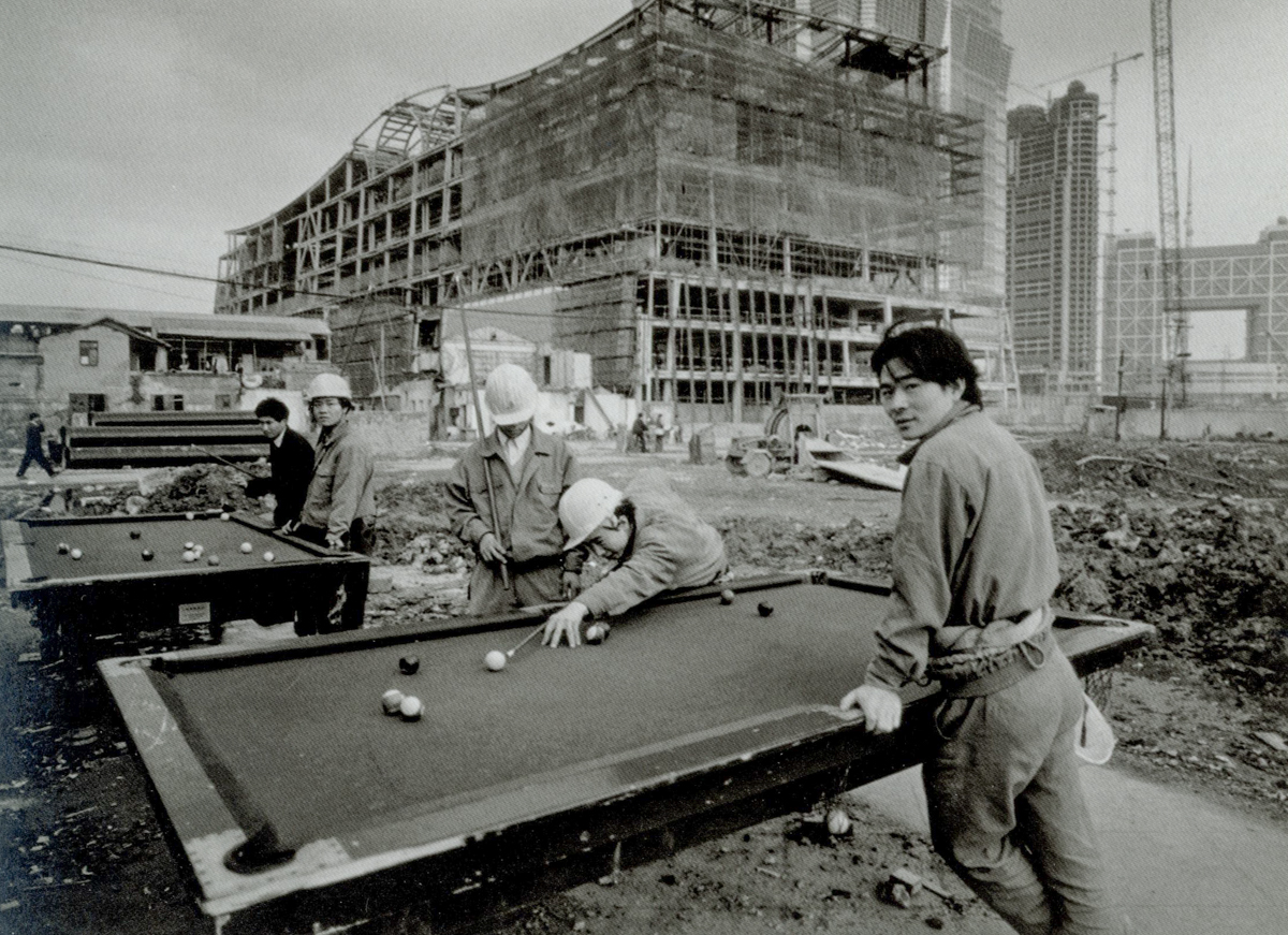 Workers play pool at a construction site on Huayuanshiqiao Road, 1997. Courtesy of Wu Jianping