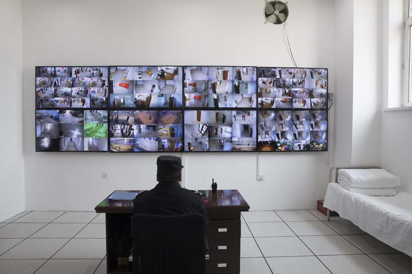 A security guard monitors the 24-hour surveillance system at a temporary hospital in Suifenhe, Heilongjiang province, April 14, 2020. Xinhua