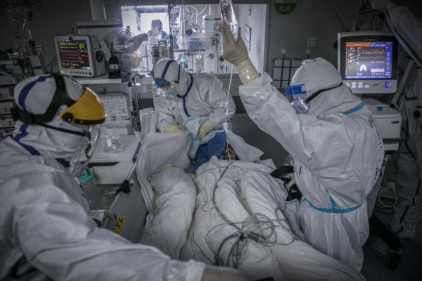 Medical workers sort equipment for a transferred patient in the Wuhan Pulmonary Hospital ICU, Hubei province, March 13, 2020. Sun Zhan for Sixth Tone