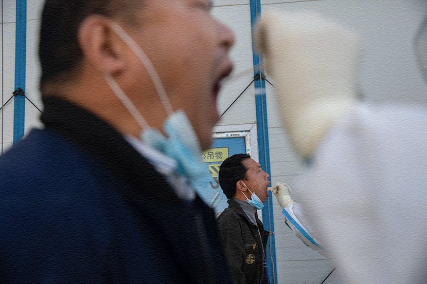 Medical workers swab workers at a construction site in Beijing, April 24, 2020. Wang Weiwei/People Visual
