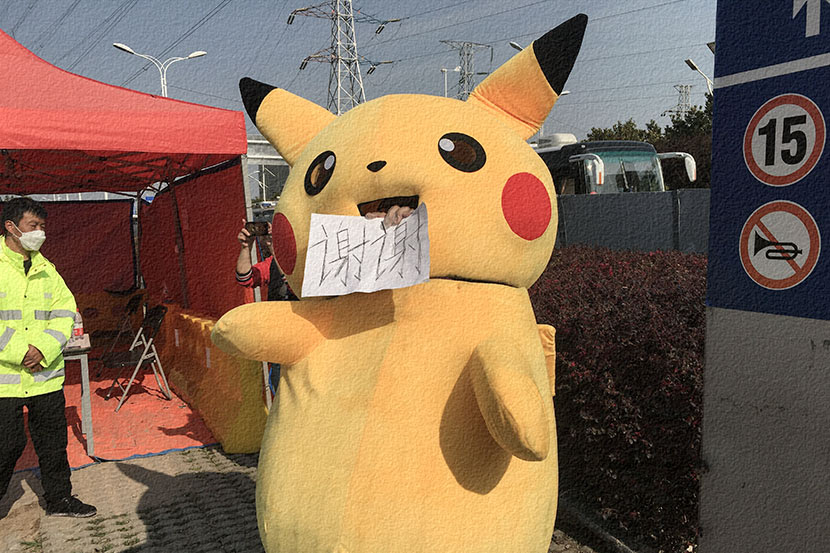 A volunteer dressed as Pikachu thanks medical relief team workers outside Keting Fangcang in Wuhan, Hubei province, March 17, 2020. Ma Furong/CNS/People Visual