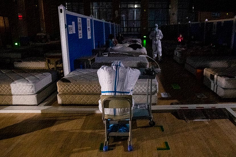 A medical worker takes a break at a “fangcang” shelter hospital in Wuhan, Hubei province, March 9, 2020. The hospital was closed on March 10. Shen Bohan/Xinhua