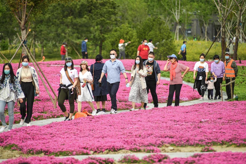 Tourists stroll through a park in Beijing, April 25, 2020. People Visual