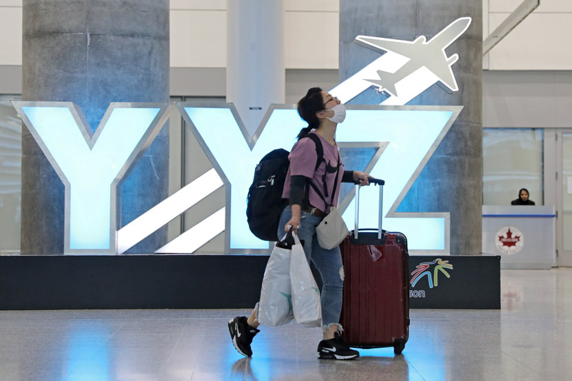 A traveler walks through the international arrivals lounge at Pearson Airport in Toronto, Canada, March 13, 2020. Chris Helgren/Reuters via Xinhua