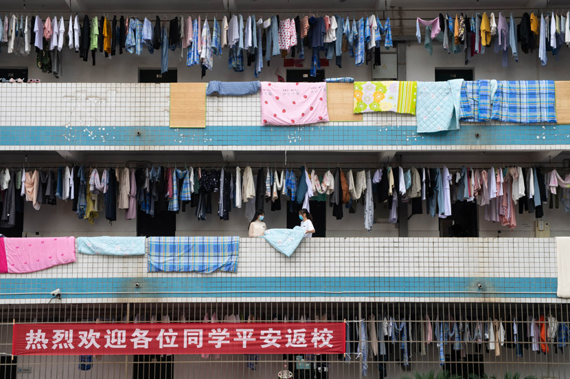 Students hang their laundry to dry outside their dorm rooms at a vocational college in Xiangtan, Hunan province, May 8, 2020. Chen Sihan via Xinhua