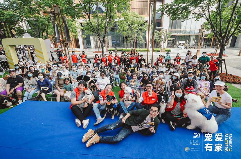 Wu Qi (front), the founder of Paw for Heal, poses for a group photo at the end of an animal-assisted therapy event at the Bund Finance Center in Shanghai, May 17, 2020. Courtesy of the Bund Finance Center
