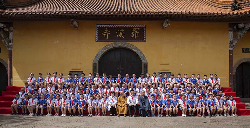 The abbot (in yellow) of the Buddhist temple poses for a group photo with the 108 children who were born there just after the 2008 Wenchuan earthquake, Shifang, Sichuan province, 2018. Courtesy of Wan Lei