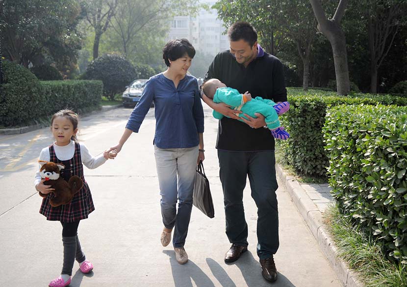 A family walk in a residential area in Xi’an, Shaanxi province, Oct. 26, 2014. People Visual