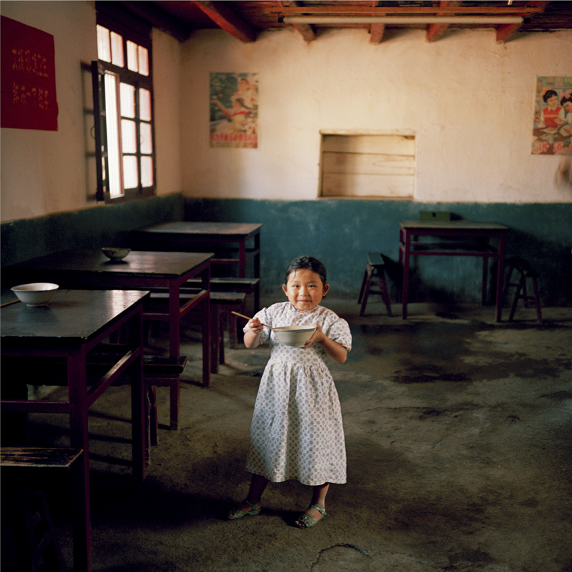 A girl poses for a photo at a rural canteen in Kunming, Yunnan province, 1981-1982. Courtesy of Ryoji Akiyama via Seisodo