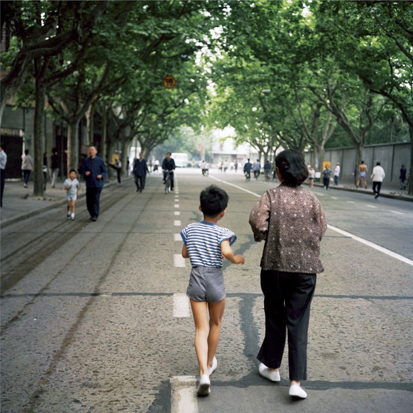 A boy goes jogging with a family member in Shanghai, 1981-1982. Courtesy of Ryoji Akiyama via Seisodo
