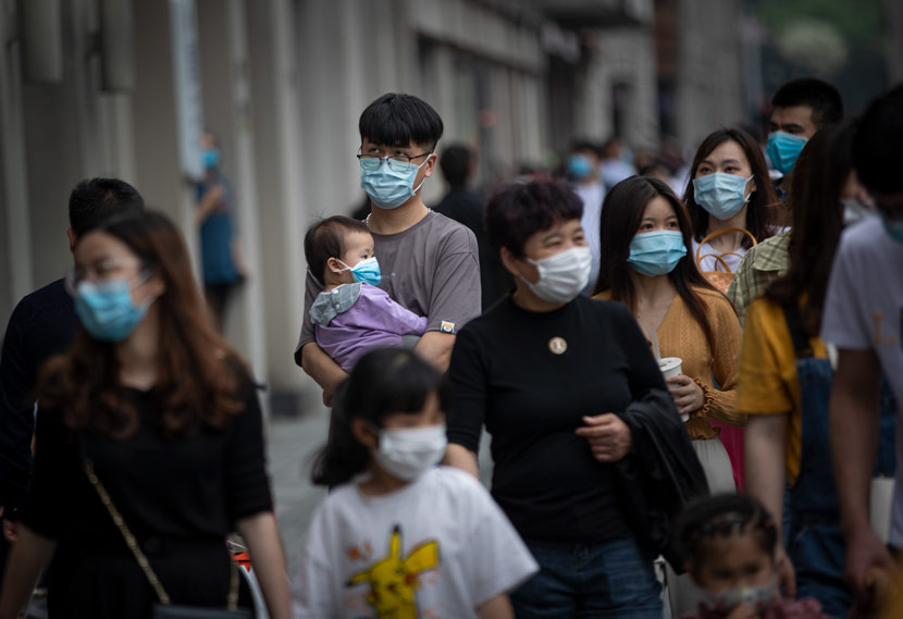 People wearing masks walk the streets in Wenzhou, Zhejiang province, May 1, 2020. People Visual