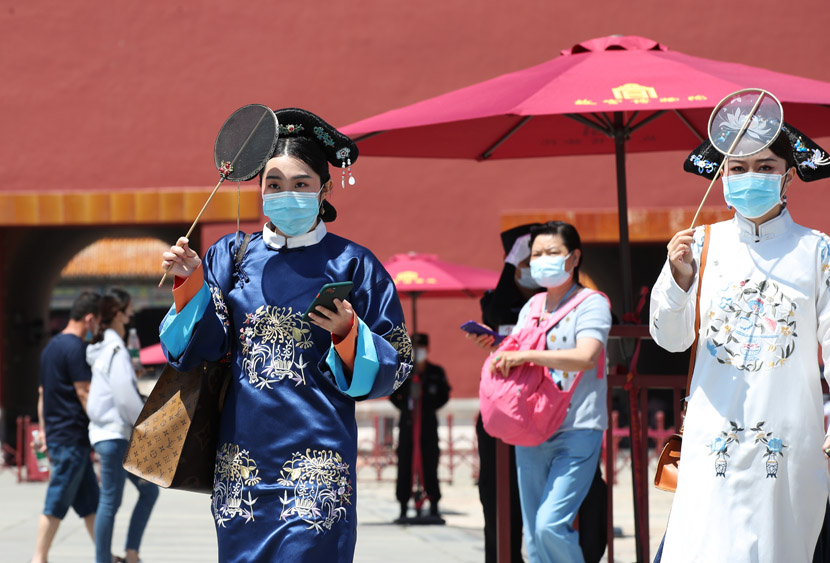 Tourists wearing Qing Dynasty garb explore the Palace Museum in Beijing, June 5, 2020. Wang Xin/People Visual