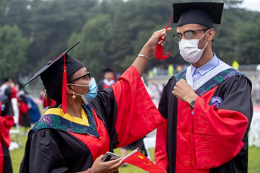 Two students attend their graduation ceremony at Wuhan University, Wuhan, Hubei province, June 20, 2020. Around 660 graduates attended the event, with thousands more watching online. Zhang Chang/CNS/People Visual