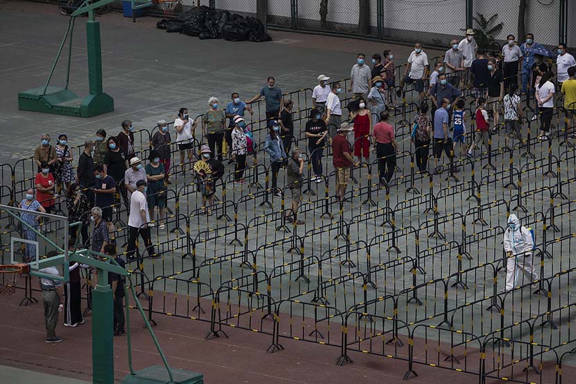 People wait to be tested at a coronavirus nucleic acid testing site in Chaoyang District, Beijing, June 23, 2020. Jiang Qiming/CNS/People Visual