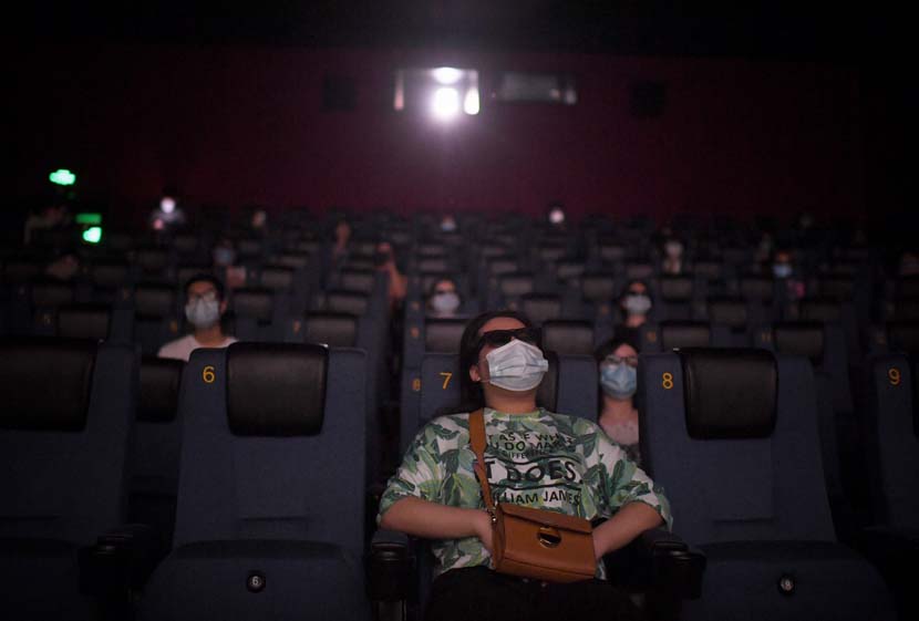 Audience members watch a film on the first day movie theaters were permitted to reopen nationwide since the coronavirus outbreak, Beijing, July 24, 2020. People Visual