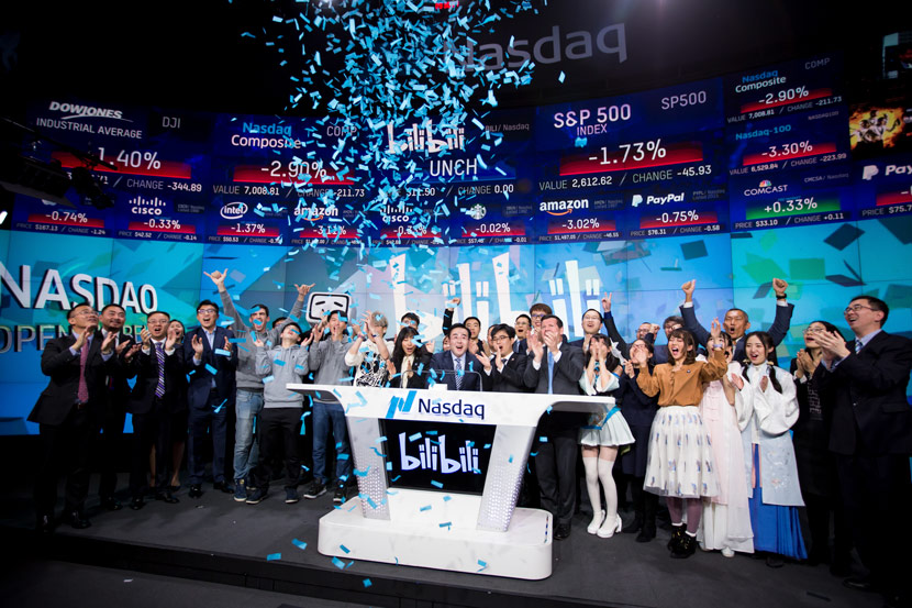 Rui Chen (center), chairman and CEO of Bilibili Inc., launches the company’s initial public offering at the Nasdaq Market Site in New York, March 28, 2018. Michael Nagle/Bloomberg/People Visual