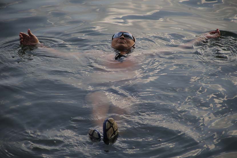 A man swims in Shichahai Lake in Beijing, Aug. 3, 2020. People Visual