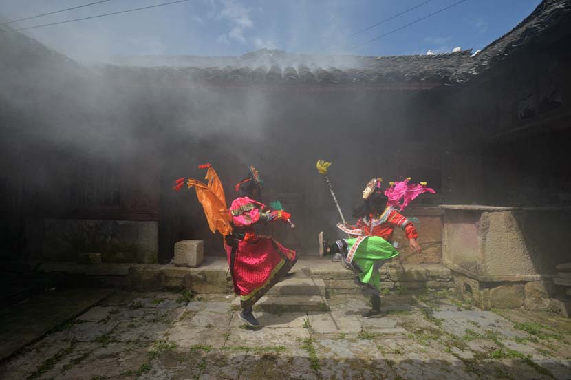 Actors perform a local opera at a village in Anshun, Guizhou province, Aug. 5, 2020. People Visual
