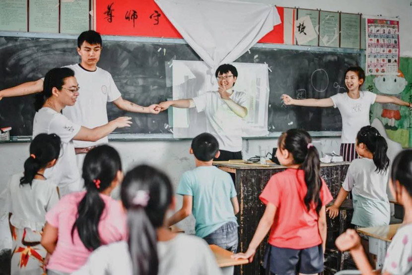 Volunteers and students take part in an activity during a sex education class at a rural primary school in 2018. Courtesy of You&Me