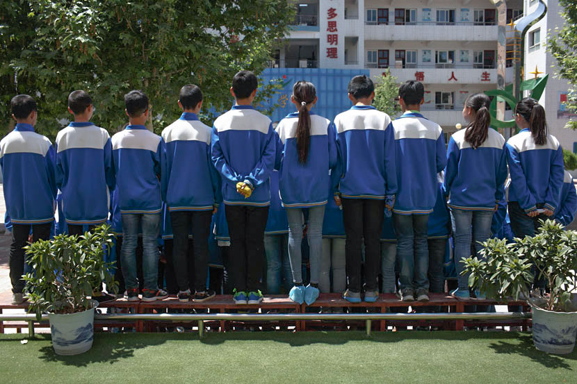 Students stand in rows for a group photo at No. 3 Middle School in Qishan County, Shaanxi province, May 17, 2017. Zhou Pinglang/Sixth Tone