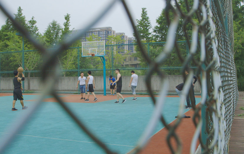 Staff and clients play basketball during exercise time at Si Guoqi Gambling Addiction Rehab Center in Shanghai, July 1, 2017. Daniel Holmes/Sixth Tone