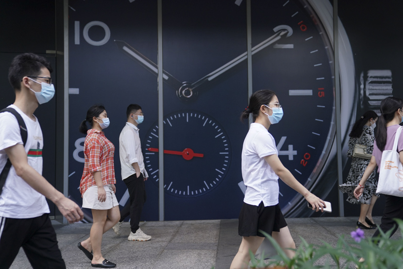 Young people walk in a commercial district of Shenzhen, Guangdong province, July 24, 2020. Su Dan/CNS/People Visual