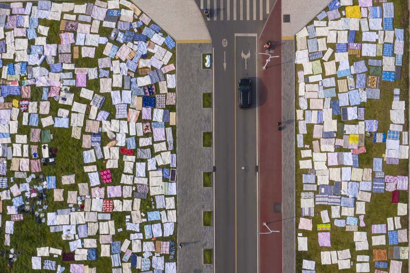 Quilts are laid out in the sun before classes start at Huazhong University of Science and Technology in Wuhan, Hubei province, Aug. 30, 2020. People Visual