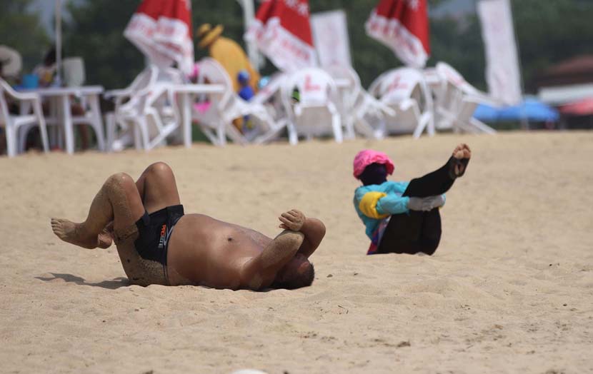 Tourists relax in the First Bathing Beach in Qingdao, Shandong province, Aug. 18, 2020. People Visual