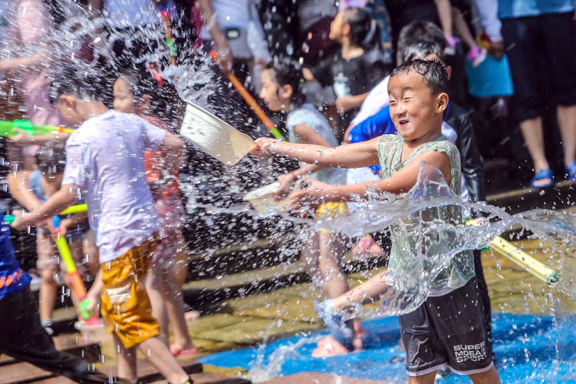 Children play with water during a water-splashing event in Jinan, Shandong province, Aug. 22, 2020. People Visual
