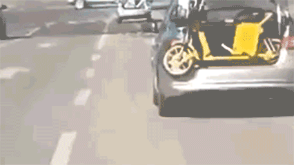A GIF shows an angry taxi driver hauling away a shared e-bike from the city center of Ordos, Inner Mongolia. From Weibo