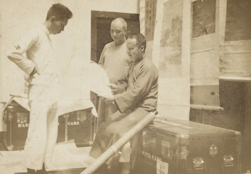 Palace Museum staff inspect part of the collection in Shanghai, 1930s. Courtesy of the Shanghai Library