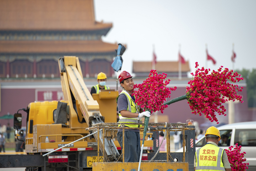 Workers arrange flower displays in Tiananmen Square prior to China’s National Day holiday, Beijing, Sept. 21, 2020. Tian Yuhao/CNS/People Visual