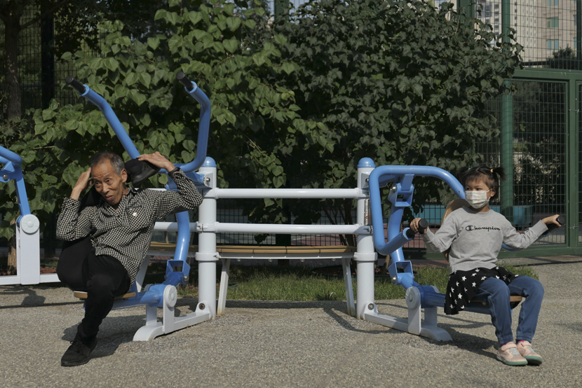 Residents try out some new fitness equipment at a park in Beijing, Sept. 25, 2020. Wei Tong/Beijing Youth Daily/People Visual